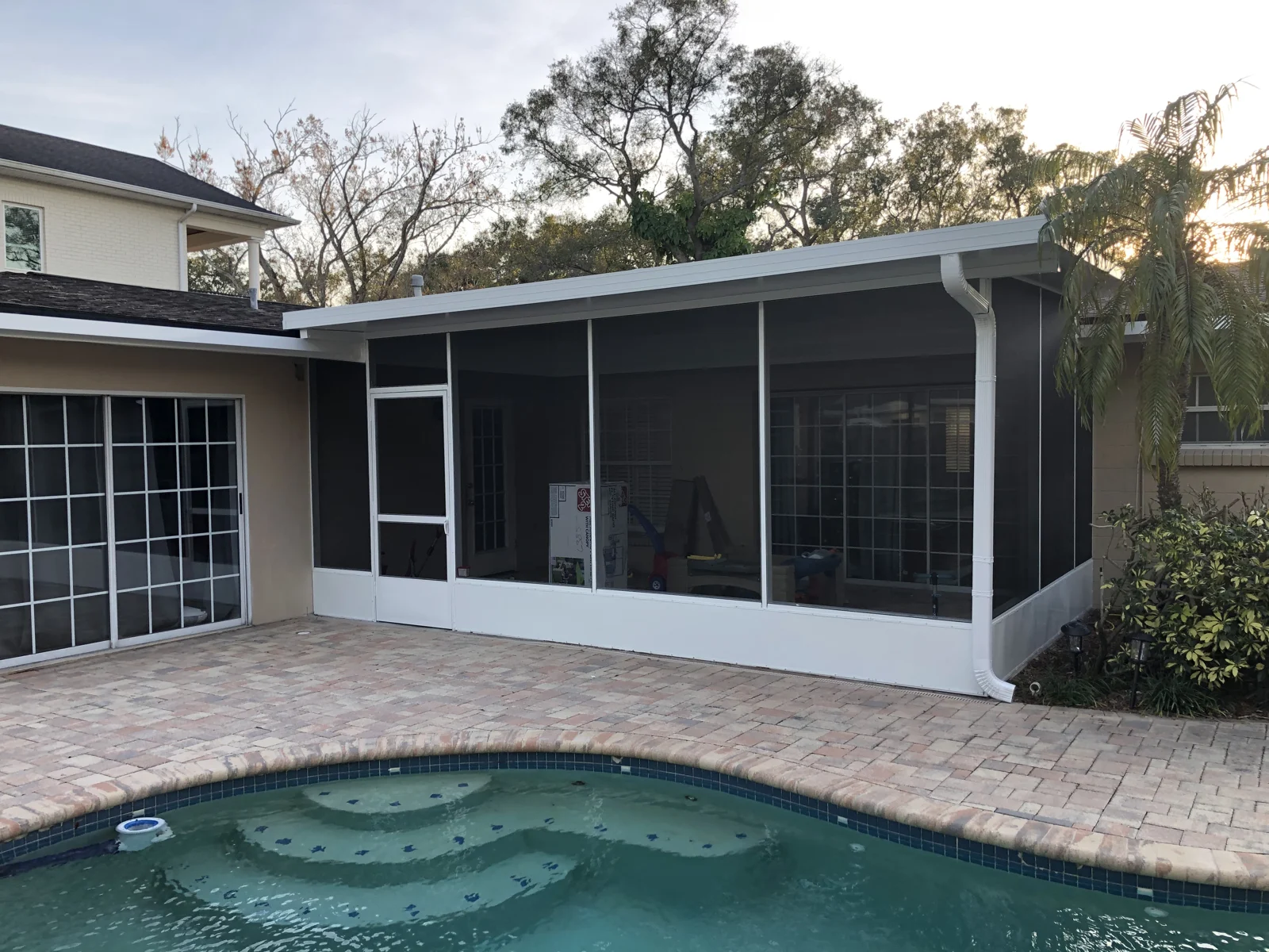 RFH screen enclosure and sunroom beside a backyard pool